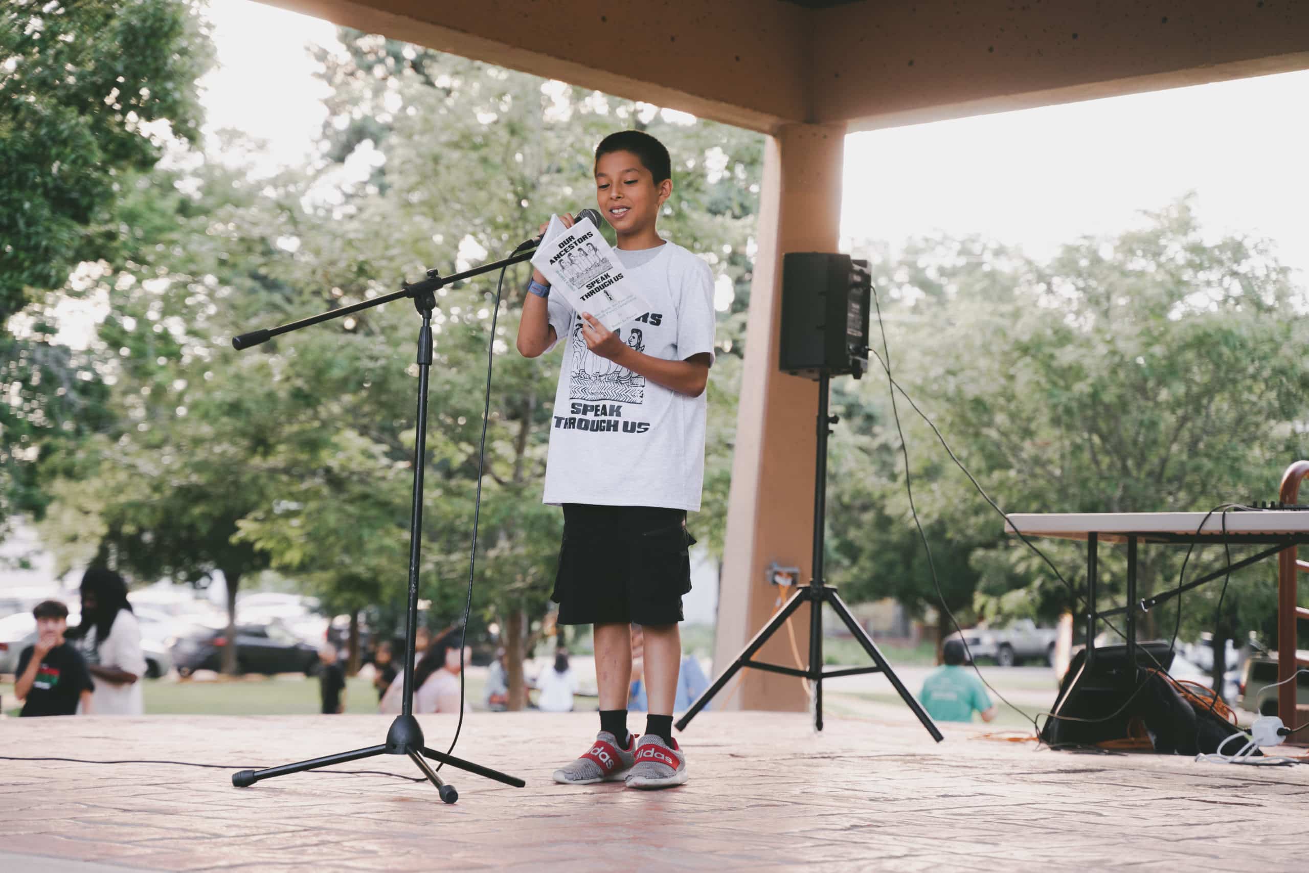 22-DSC00044 Student reading his poem from the book