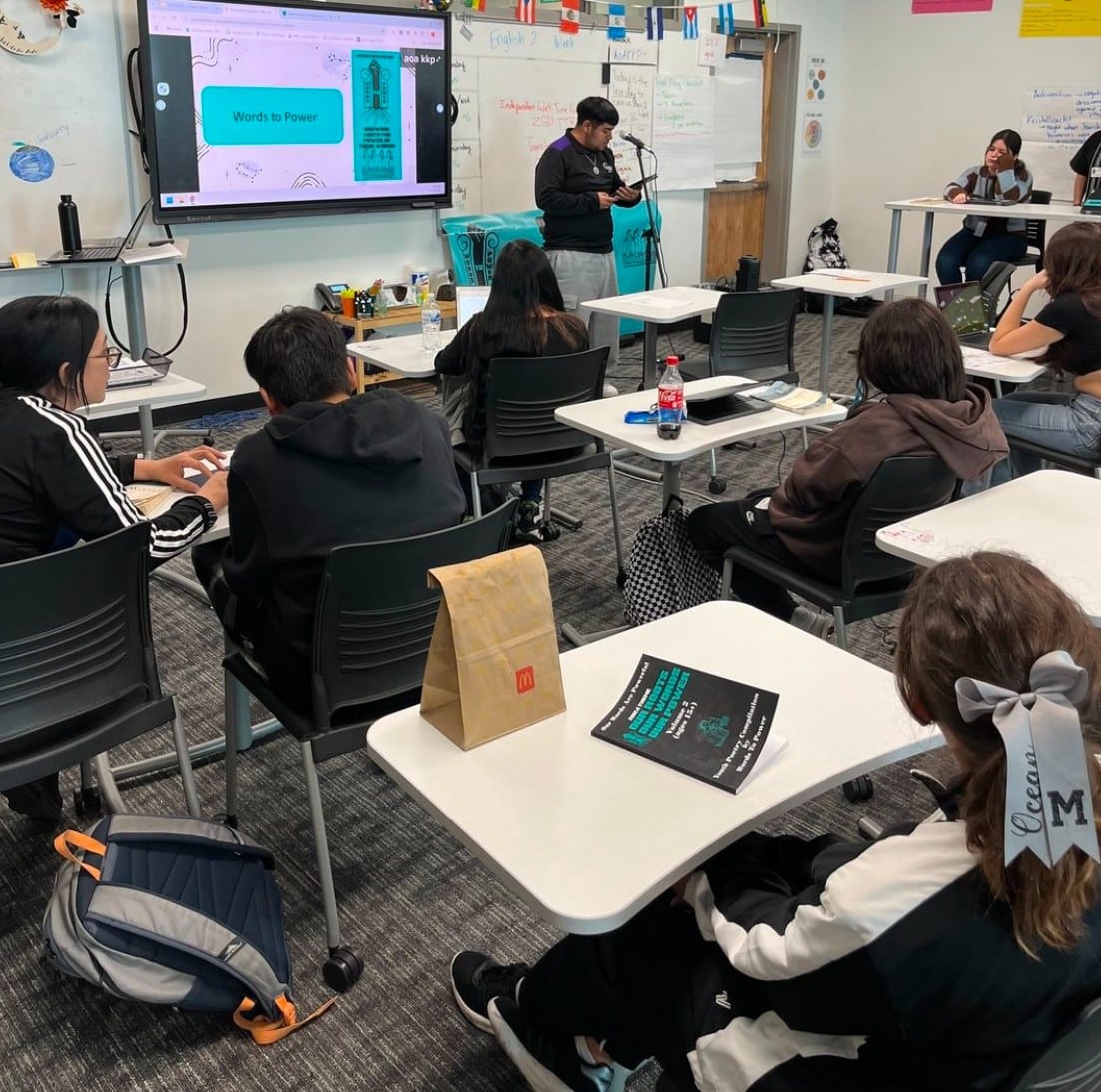 IMG_3072 Photo of high schooler student reading his poem for his class